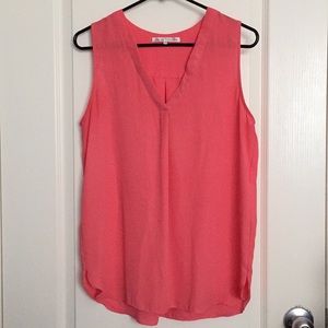 Pink sleeveless blouse.